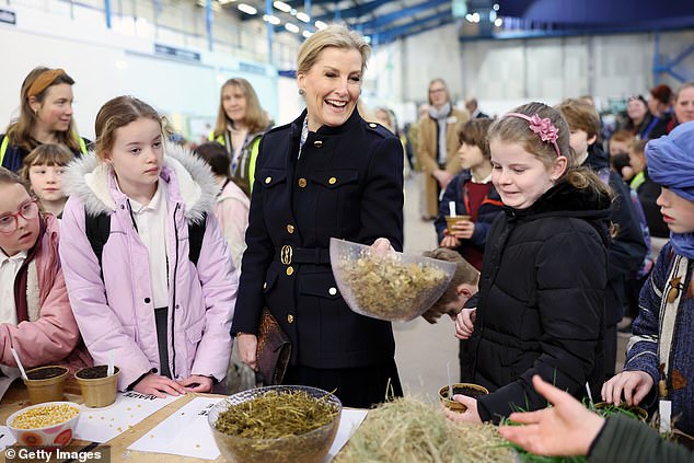 In one snapshot, she was seen marveling at a jar of fresh apples. In another, she and a group of young children looked at a selection of herbs and grains. Elsewhere, the royals were also able to see a bee hive and some sheep in a pen.