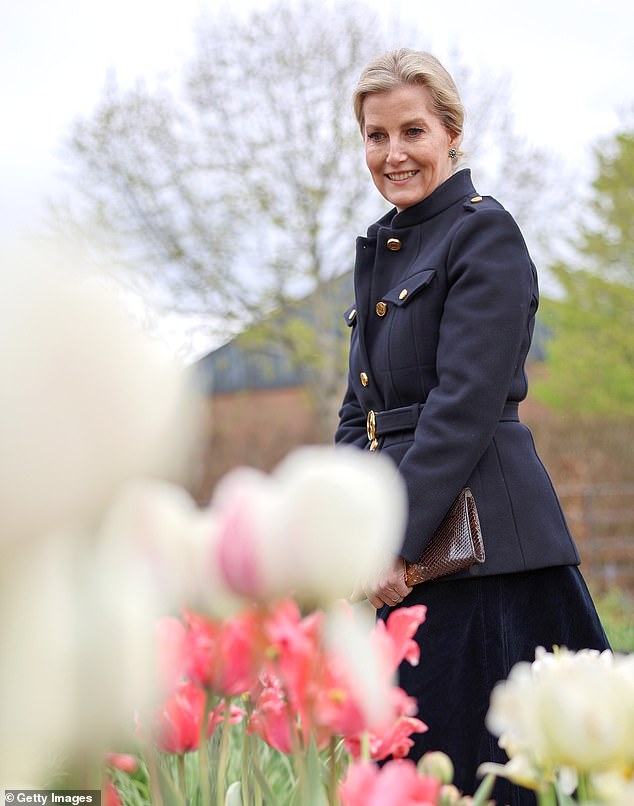 Looking typically elegant, the Duchess donned a sophisticated mid-length navy blue coat with gold buttons.