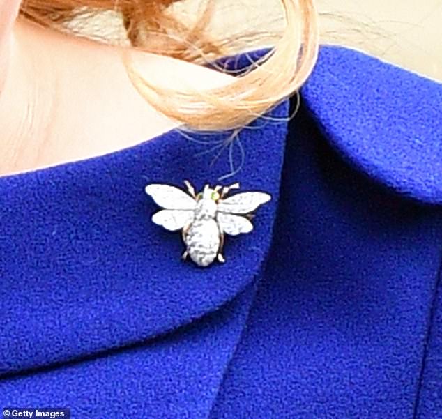 This youngest member of the Windsors carries a bee on top of a thistle
