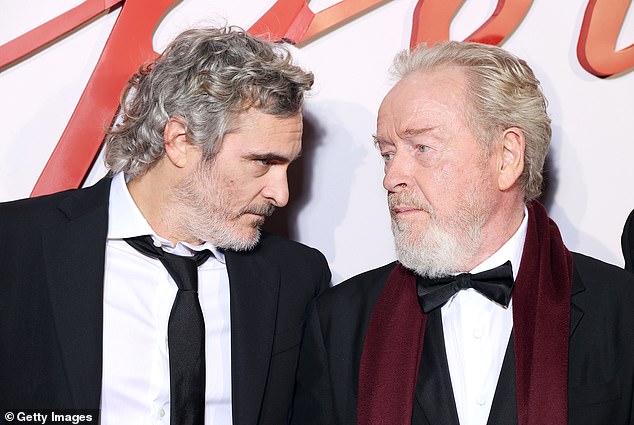 He said: 'I don't know what I was thinking.  I think it's totally his fault and I don't think Ridley Scott will help him (pictured with Phoenix and Scott in November 2023)