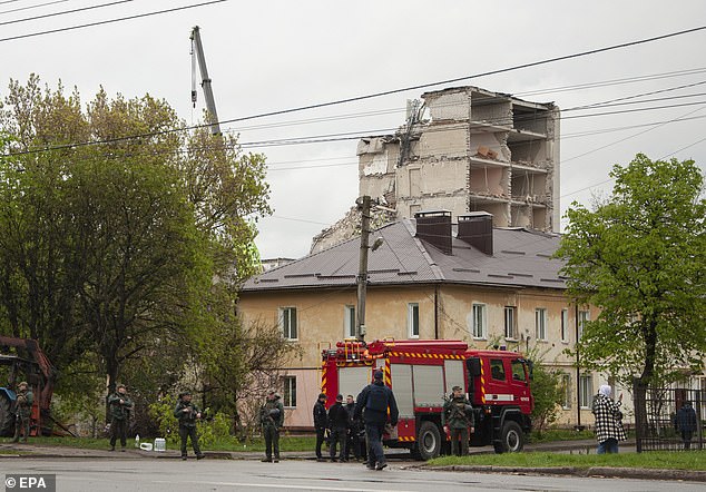 Police officers stand watch near the site of a missile attack in Chernihiv, northern Ukraine, on April 17, 2024.