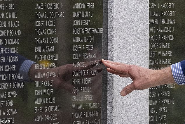 President Joe Biden touches the name of his uncle Ambrose J. Finnegan, Jr., on a wall of a Scranton war memorial, Wednesday, April 17, 2024, in Scranton, Pennsylvania.