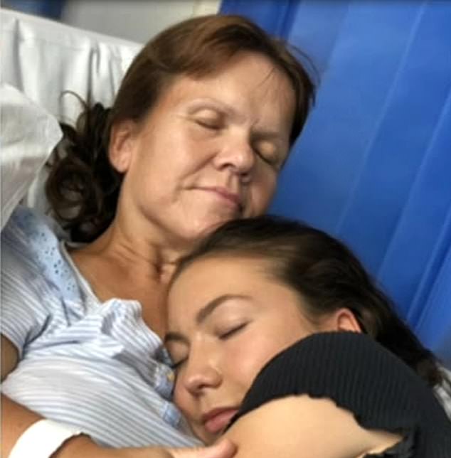 Samantha Davis came close to death in 2019 when she fell ill with sepsis before a family vacation. Above: hugged by her daughter in the hospital