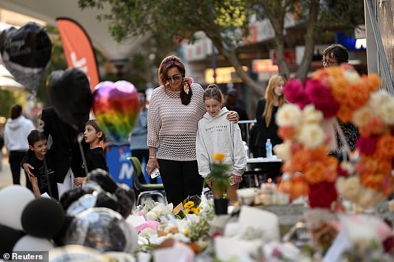 People leave floral tributes to the victims after the attack at the Westfield Bondi Junction shopping center on Saturday, in Sydney, Australia, April 17 2024.  REUTERS/Jaimi Joy