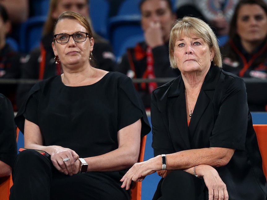 Ali Tucker-Munro sits next to Giants head coach Julie Fitzgerald at a game