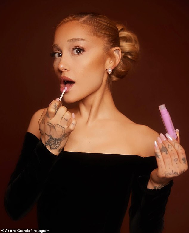 The Grammy-winning artist was seen applying lip gloss in a separate shot.