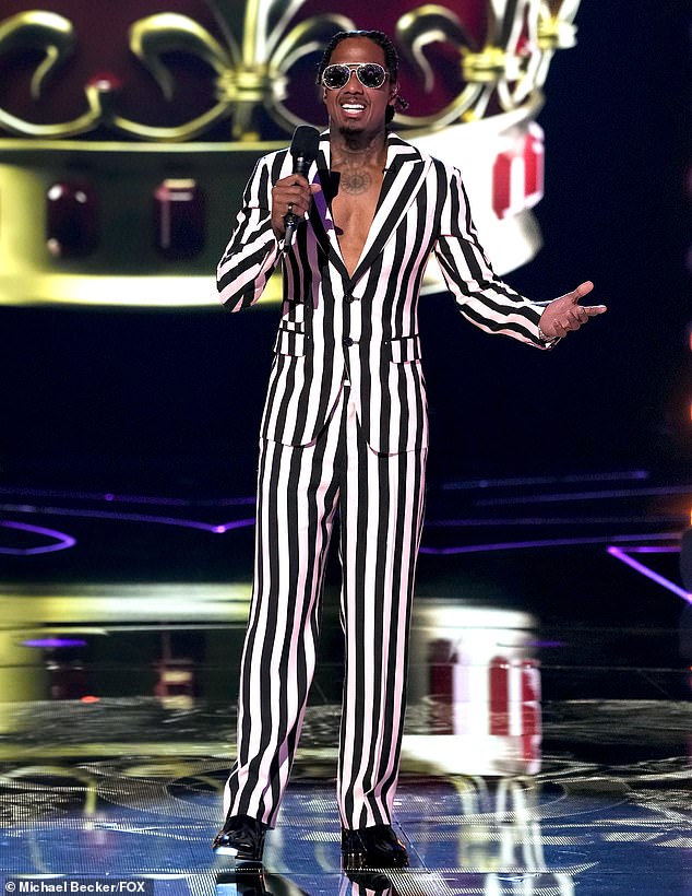 Nick Cannon wore a black and white vertical striped suit with no shirt while presenting