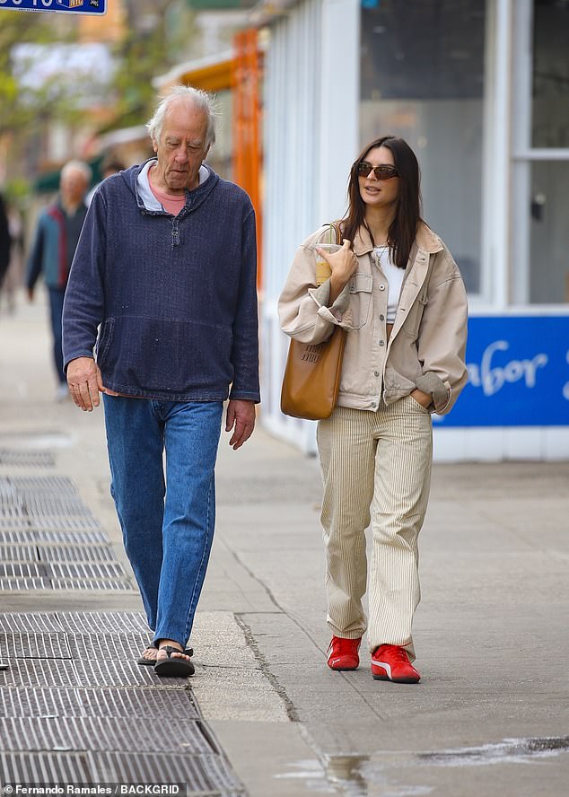 John towered over his 5ft 7in daughter in blue jeans, sandals and a comfortable blue jumper.
