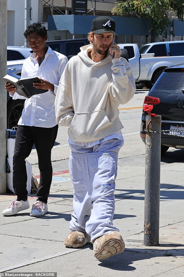 Justin stayed comfortable as he paired the extravagant shoes with two pairs of gray Balenciaga sweatpants, one of them pulled low around his thighs.