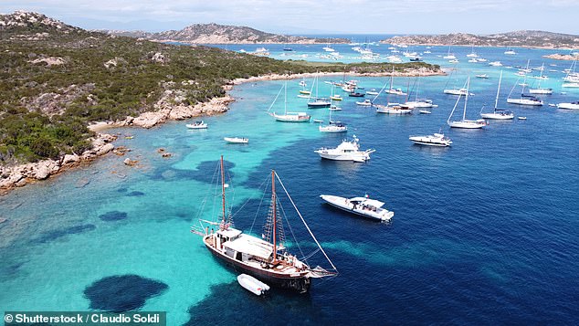 A boat trip is the only way to appreciate the beauty of Sardinia's seas, says Rob.  In the photo: Boats anchored near the shores of Budelli Island.