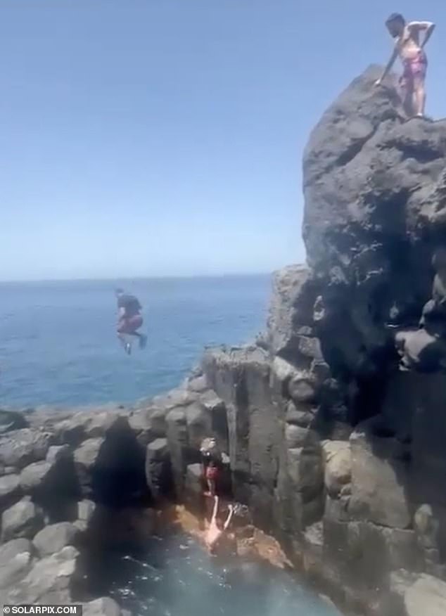 The man jumped too far, over the pool below and towards the rock outcropping.