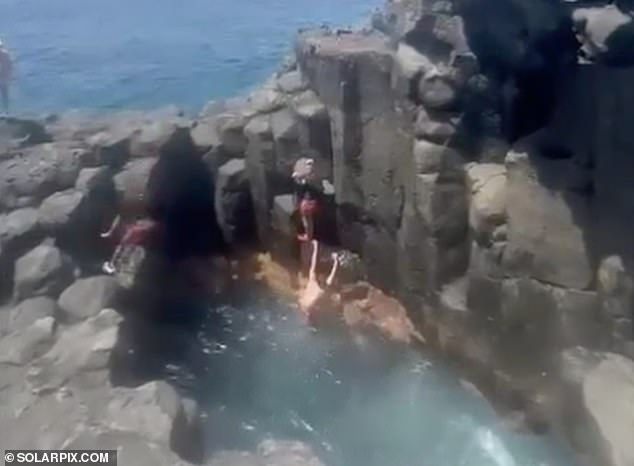 Witnesses could be heard reacting with shock and terror as the unfortunate jumper made contact with the rocks before bouncing into the water.