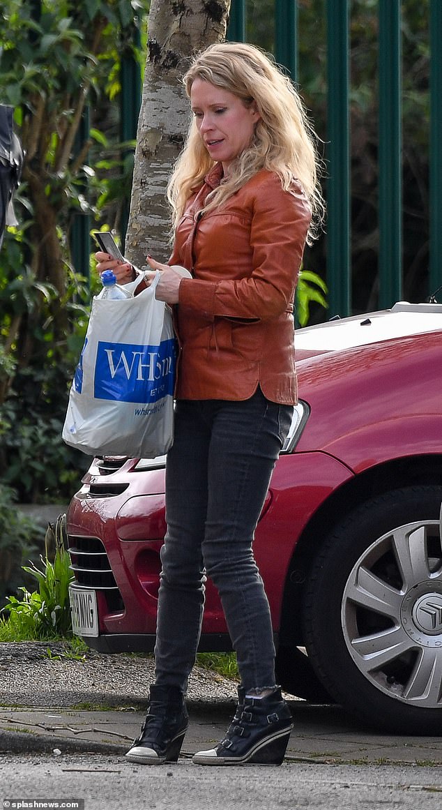 During the outing, Lucy wore a tan jacket with skinny jeans and high-heeled boots and carried a WHSmith bag.