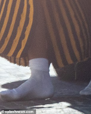 She arrived at her hotel in just socks after ditching her heels at some point.