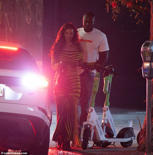 While returning to their hotel in the morning in a chauffeur-driven car, earlier in the evening the fun couple was seen using some of Los Angeles' electric scooters to get around.