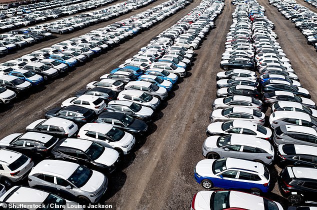 An aerial view of rows of newly built cars and vehicles ready for export, import and delivery to sales dealers in Tamworth, UK