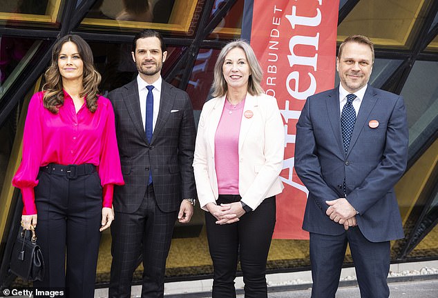 Princess Sofia and Prince Carl Philip of Sweden pose for a photograph with organizers Jessica Stigsdotter Axberg and Eric Donell