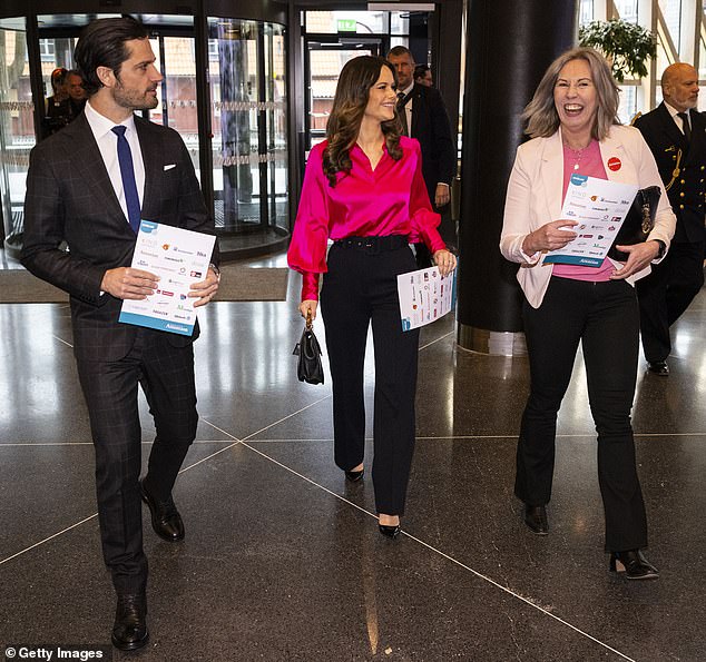 Princess Sofia laughs with one of the organizers, Jessica, as they enter the forum building.