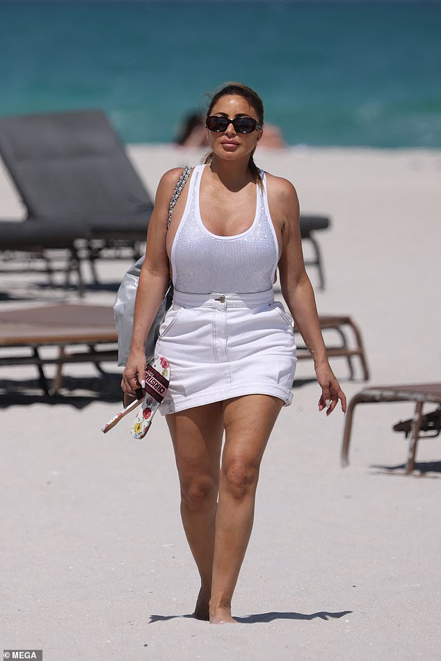 Larsa showed off her hourglass curves and side boob in a skimpy white swimsuit with her locks pulled back into a ponytail.