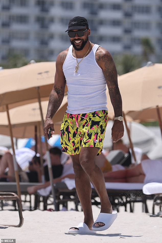 Marcus looked fashionable as he strolled along the beach.