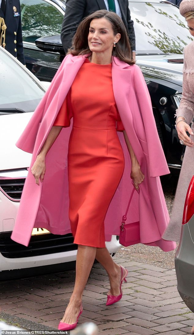 The Queen of Spain looked in top shape today with a red and pink outfit that showed off her elegant figure.
