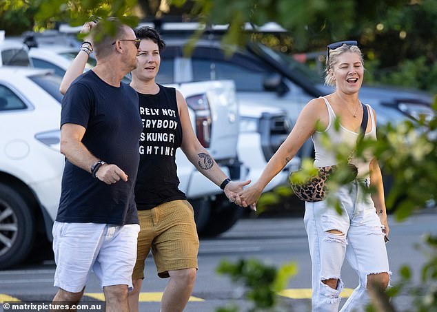 Looking absolutely smitten, Natalie smiled and joked with Pip as the pair held hands while walking through an outdoor car park.