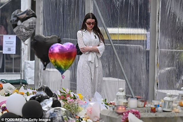 Findlay said he received dozens of messages from his friends after a possible misogynistic motive for Saturday's stabbing was revealed (pictured, a woman at the memorial).