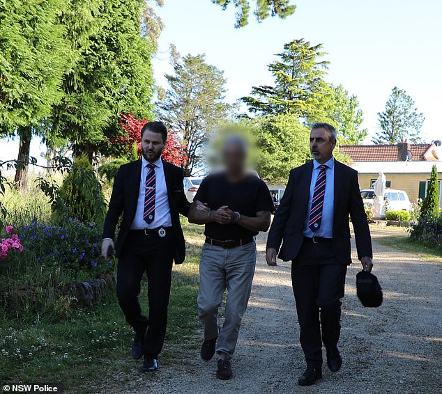 Steve Nassif (pictured with detectives) was arrested at his Blue Mountains estate three months after the mansion fire.