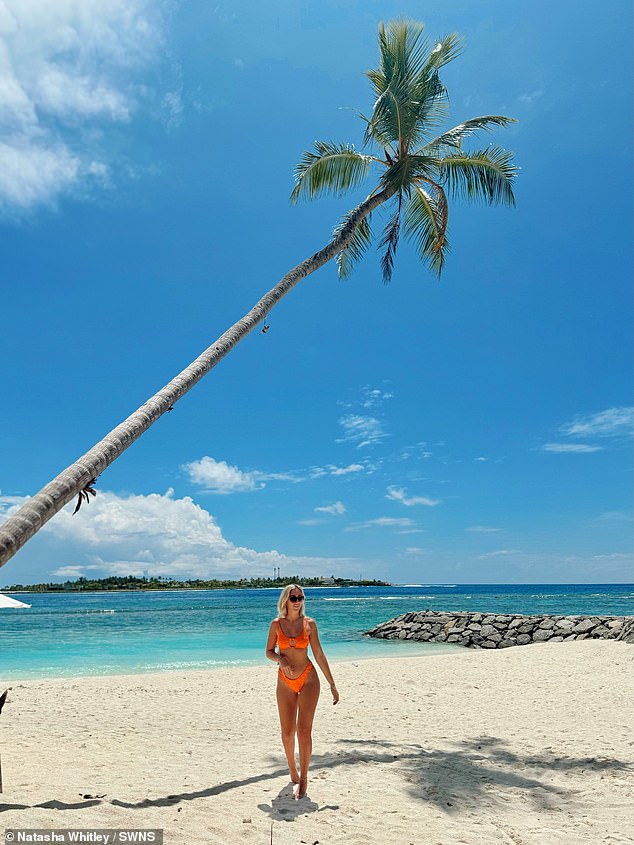 Natasha strolls along the stunning beach in a bikini on Thulusdhoo, a local island in the Maldives.