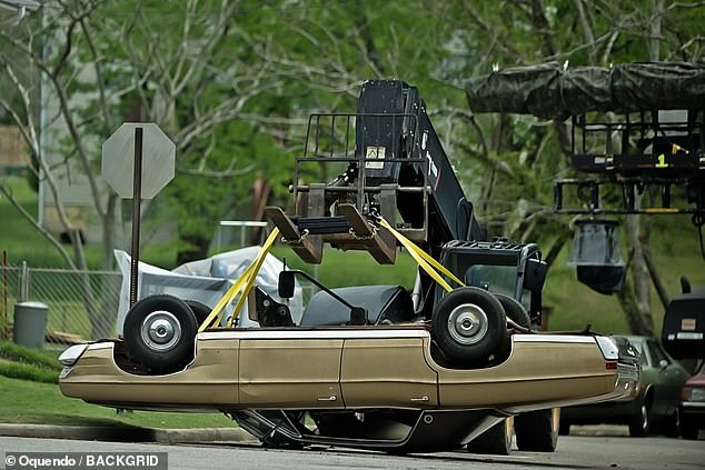The scene that was filmed that day evidently involved an overturned car, as a crane could be seen lowering an antique car upside down into the street.
