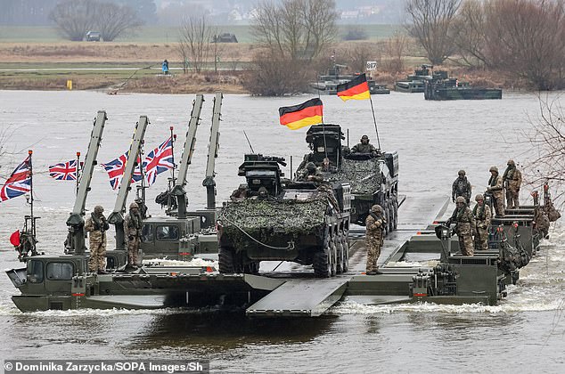 German and British military personnel transfer tanks and armored vehicles across the Vistula River during NATO exercise Dragon-24, part of the large-scale exercise Steadfast Defender-24.
