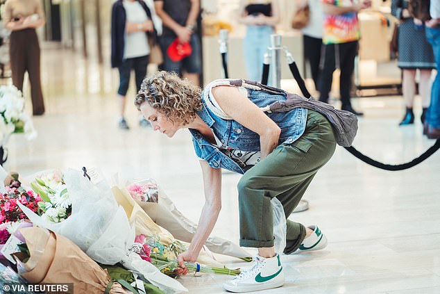 Australians were quick to react to her take on the day of reflection, with many advocating for the safety of retail staff at Bondi Junction (pictured, a woman leaves flowers at the memorial).