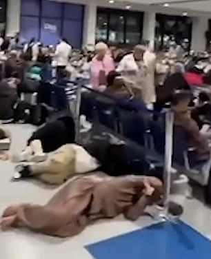 Images from inside the airport, the world's busiest for international travel, showed passengers sleeping on the floor while waiting for flights out of the country, after dozens of them were stranded following torrential rains.