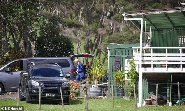 Police are seen at the home of a couple who were reportedly killed by a ram on their property