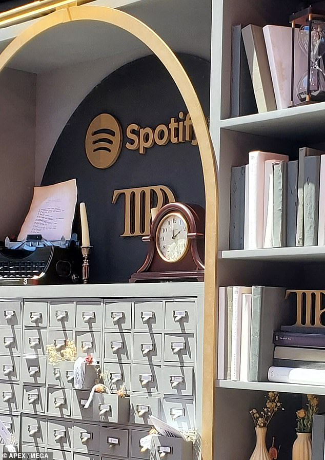 At his Tortured Poets Spotify library installation in Los Angeles there was a figurine with a peace sign and another clock set at 2 o'clock.