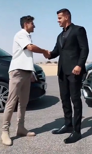 Taylor shakes hands with the owner, who says the former player's experience is 