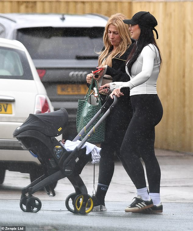 During her outing with a friend, the new mum smiled as she pushed the baby in a £339 Nitro Black Doona+ car seat and stroller and wore activewear.