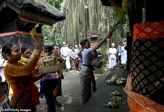 Balinese take part in a purification ritual at the Beji Temple, located inside a monkey sanctuary in Ubud, on the resort island of Bali, Indonesia, on August 15, 2019.
