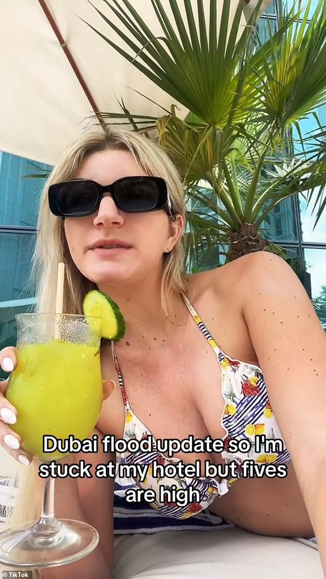 A TikToker shared an update from her hotel while relaxing poolside in a bikini with a cocktail.