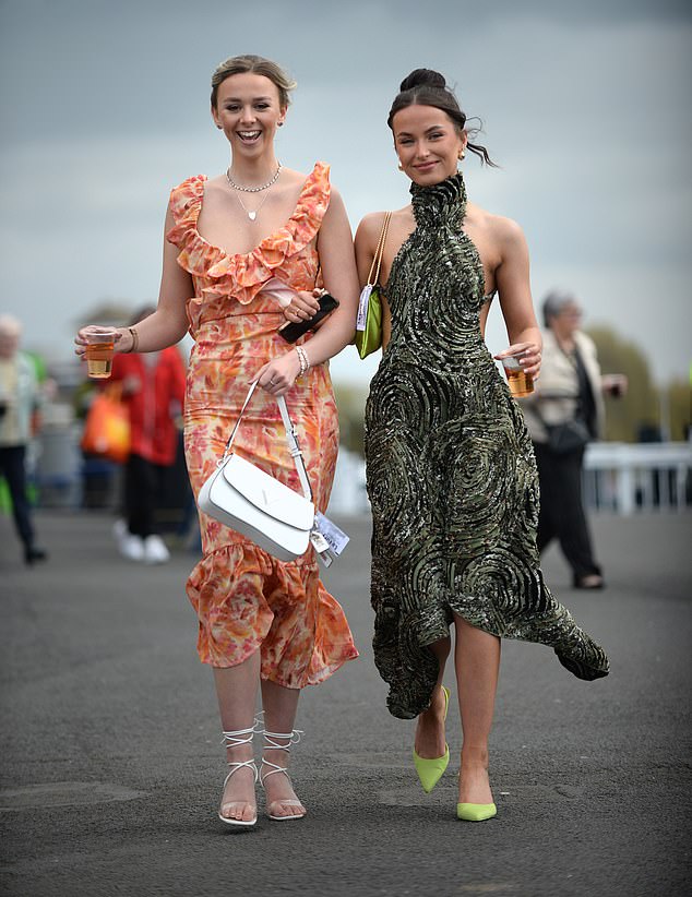 One woman channeled spring in a bold green halter neck print dress, which left her back exposed to the windy weather.