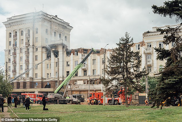 Firefighters and rescuers work at the site of the Russian missile attack, extinguishing a fire and rescuing people from the rubble of a residential building damaged by Russian shelling on April 19, 2024 in Dnipro, Ukraine.