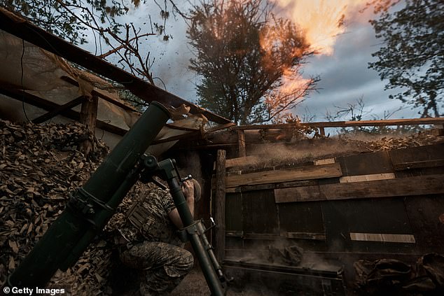 Ukrainian assault brigade soldiers inflict fire damage with a 120mm mortar while supporting infantry assault operations April 19, 2024 in Ukraine.