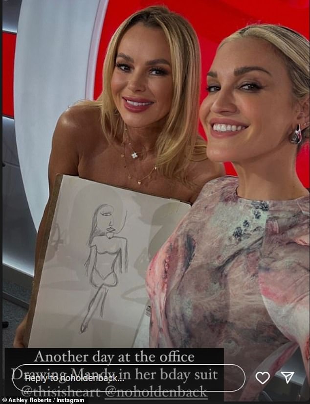 Ashley posed for a photo with Amanda in her 'birthday suit', who was holding one of her drawings.