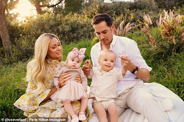 The socialite, 43, who welcomed London via surrogate in November, posed with her husband Carter Reum, 43, and their son Phoenix, in one of the first snaps.