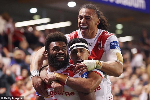 Dragons' Mikaele Ravalawa celebrates with his teammates after scoring a try during the club's big win over the Warriors.