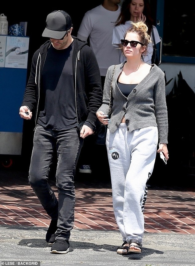 Each of the couples opted for a casual ensemble, with the Pretty Little Liars alum wearing light gray sweatpants, a black top under a charcoal sweater, and black sandals.