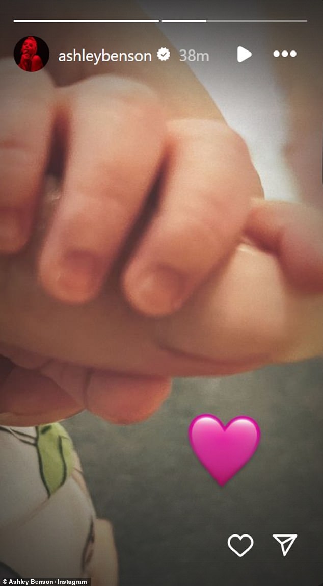 Benson announced the news of her daughter's arrival with a sweet photo of her little hand as she clutched one of her mother's fingers.