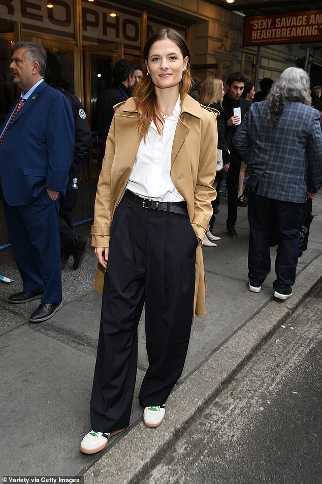 Actress Louisa Jacobson, 32, color blocked in a khaki coat, white shirt and dark pants.