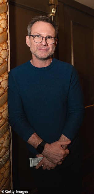 Actor Christian Slater wore a blue crew-neck sweater.