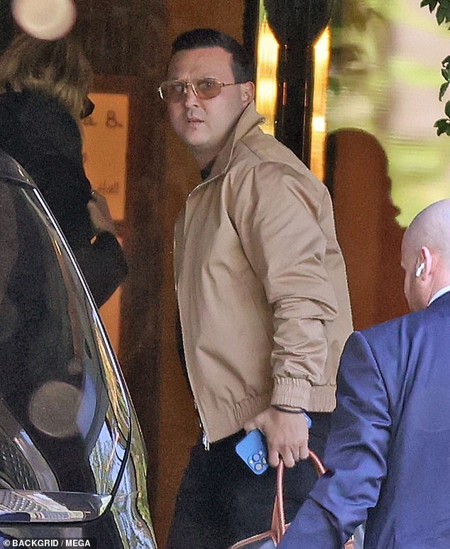 The 35-year-old completed his outfit with orange aviator sunglasses and white sneakers.